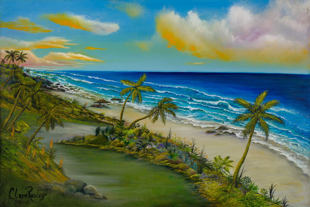 an oil painting in landscape of the Hawaiian Island with a bright sky depicting an afternoon with clouds reflecting orange and yellow within the puffy clouds moving in the trade winds. The sea is rough as the waves crash on the sand and volcanic rocks and the realistic palm trees growing on the lush flower beds that border the grassy and sandy path that leads to the Pacific